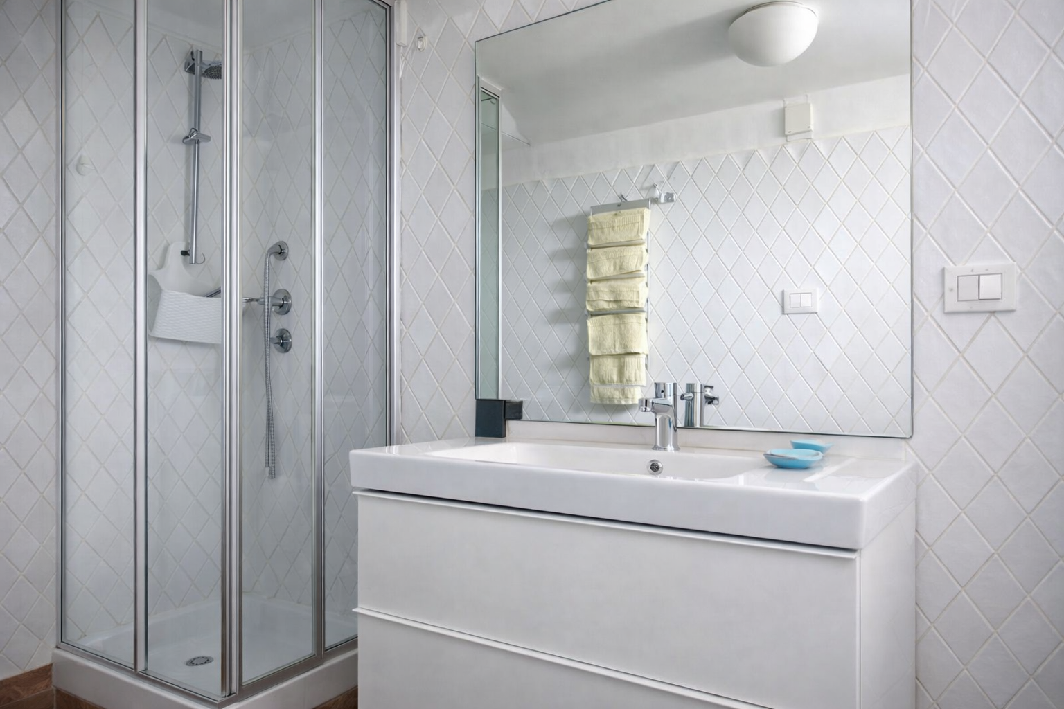 Bagno di AMALFI Sea House con doccia in vetro, piastrelle bianche a rombi, lavabo moderno e rubinetteria cromata elegante - casa vacanze Amalfi Costiera Amalfitana